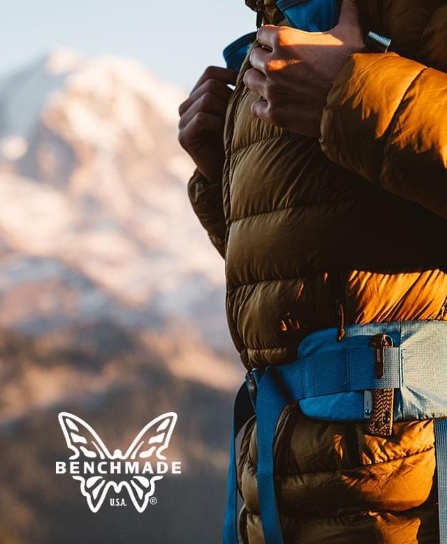 hiker standing infront of mt. rainier with a knife in his belt