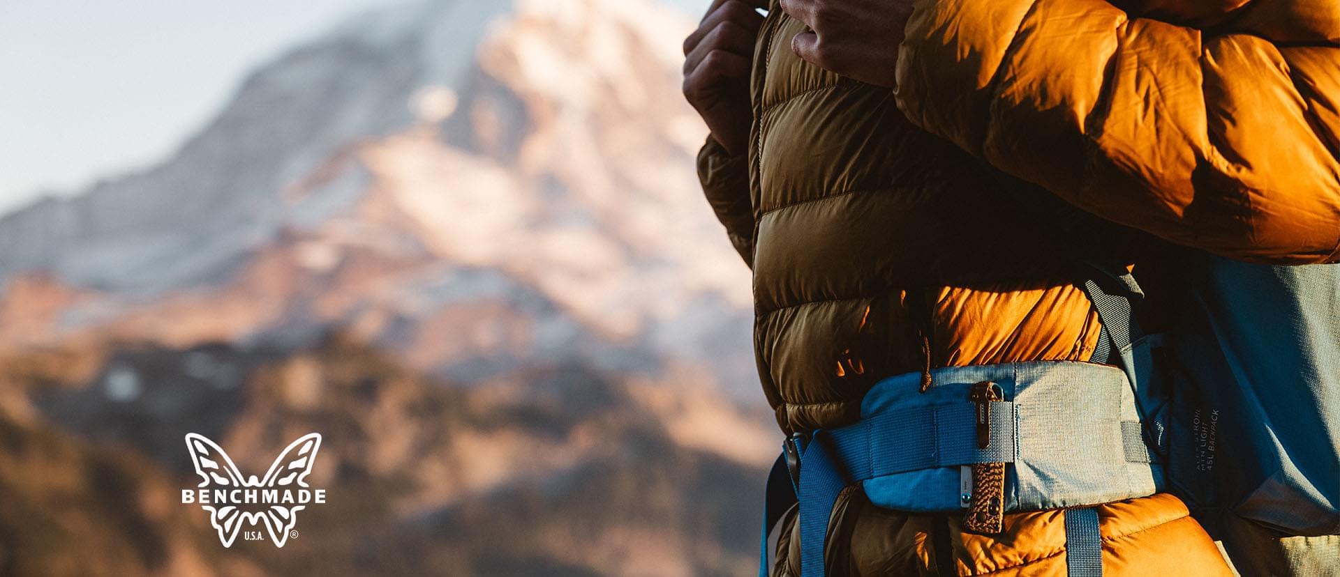 hiker standing infront of mt. rainier with a knife in his belt