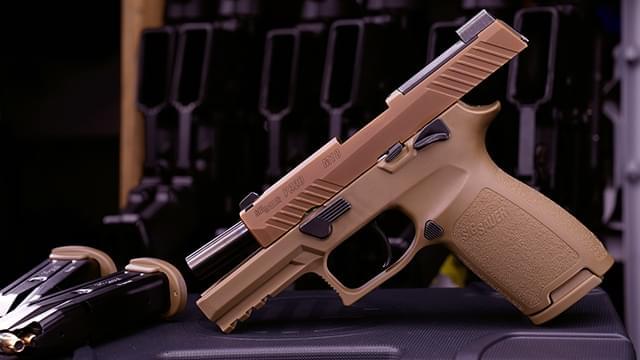 Sig handgun with magazines